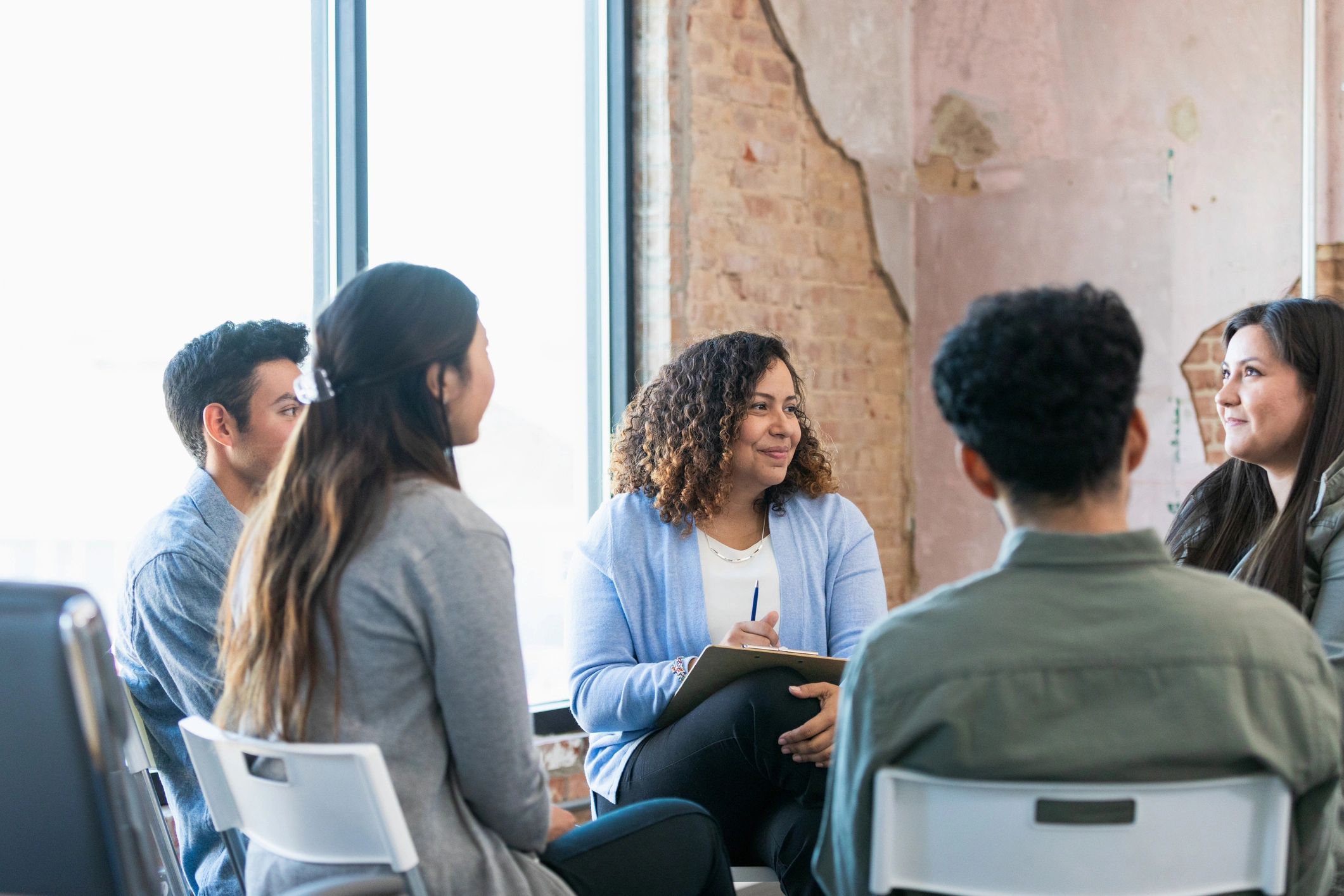 A small group meeting in a supportive setting.